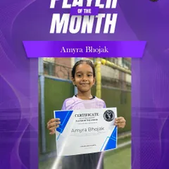 Amyra Bhojak, one of our talented young players from the Thakur International School batch, proudly holding her Player of the Month certificate.