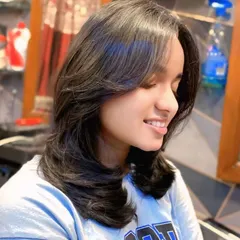 This is the result of a perfect layered haircut with feathered ends. The style adds incredible volume and movement, and the blowout styling makes the layers stand out beautifully.