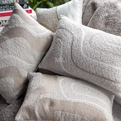 Another view of our textured bouclé cushions, highlighting the abstract embroidered lines that add understated luxury and comfort to your lounging experience.