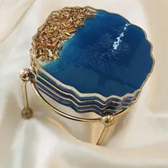 Another view of the blue and gold coaster set, stacked and ready to go with its metal stand.