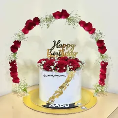 A romantic birthday cake featuring an arch of fresh red rose petals and baby's breath. Learn how to create stunning floral arrangements on and around your cakes.