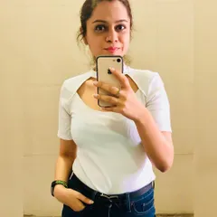 Basics are the foundation of a great wardrobe. This white tee with a unique scoop neckline adds a modern twist to a classic piece, pairing perfectly with dark blue denims for a clean, summery look.