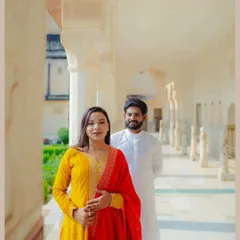 A classic portrait taken in the beautiful corridors of an Udaipur palace. The soft light and repeating arches create a stunning backdrop, highlighting the couple's elegant traditional wear during their destination pre-wedding shoot.