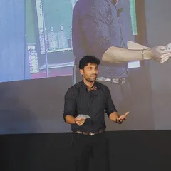 A demonstration of advanced card handling, or a "flourish," on stage. While it looks cool, this level of skill is essential for executing the seamless sleight of hand that makes my card tricks so deceptive.