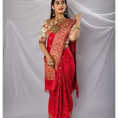 The bride looks radiant in her red silk saree, a perfect example of a classic South Indian bridal portrait.