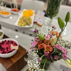 A beautiful table display we created for a store opening. The setup features our fresh dips, olives, and floral arrangements, creating an inviting atmosphere for guests.
