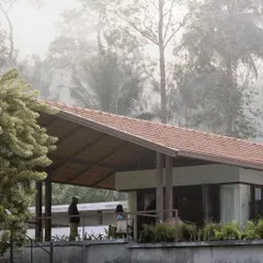 The house is perched on the edge of the estate, with a covered veranda offering panoramic views of the misty valley. This is a space designed for quiet contemplation and enjoying the cool climate.