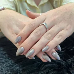 Another view of the elegant gunmetal chrome nails. This pose highlights the smooth, mirror-like finish and the unique color that complements any style.
