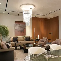 From this angle, you can see how the living area's plush seating and the dining space's elegant marble table coexist. The design ensures the home feels functional for daily life and elevated for entertaining guests.
