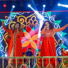 On stage, we feed off the crowd's energy. Here we are, getting everyone hyped up during a Navratri performance, with our amazing band providing the perfect backdrop.