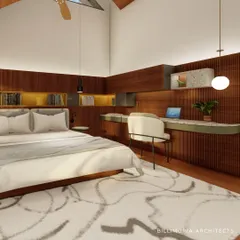 This bedroom in Palm Meadows features warm wood paneling and a built-in desk, creating a cozy and functional space. A skylight and large window fill the room with natural light, enhancing the sense of calm.