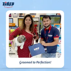 A pet parent proudly holds her freshly groomed Shih Tzu and a goodie bag. Our fests are all about celebrating perfectly groomed pets and happy customers.