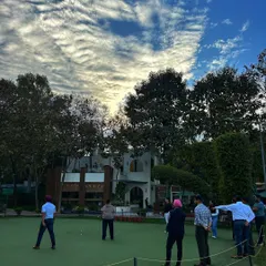 A group gathers on the putting green under a dramatic sky. It’s a fantastic social activity and photo opportunity for any celebration.
