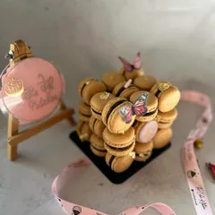 A still shot of the macaron tower, adorned with delicate wafer paper butterflies. It's perfect for birthdays, bridal showers, or any elegant affair.