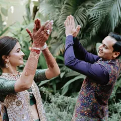 A fun, candid moment between the couple. The bride's natural-looking makeup ensures she looks like herself, just with an extra touch of bridal glow.