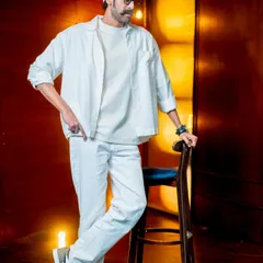A full-length shot of the all-white ensemble for Rana Daggubati. The relaxed fit of the shirt and pants, paired with classic sneakers, creates a look that is both comfortable and incredibly stylish.