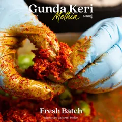 Our team's hands, covered in the rich masala, carefully mix the Gunda Keri pickle. This personal touch ensures the spices are evenly distributed for the perfect flavour in every bite.