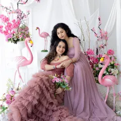 A beautiful portrait of a mother and daughter for our Mother's Day mini-session. The pink floral and flamingo theme creates a vibrant and loving atmosphere.