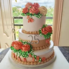 This three-tiered floral cake was created for a 25th wedding anniversary, featuring beautiful hand-piped roses and an elegant colour palette.