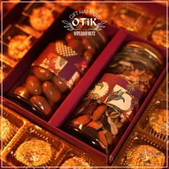 This premium Diwali hamper is designed for elegant gifting. It features jars of assorted nuts and chocolate-covered almonds, surrounded by decadent, gold-wrapped chocolates, all presented in a luxurious gift box.