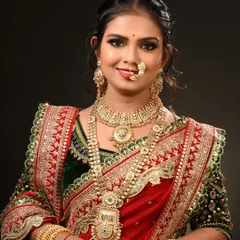 This is a traditional Maharashtrian bridal look, complete with the iconic nath and chandrakor bindi. My course covers regional bridal styles, ensuring you can cater to a diverse clientele.