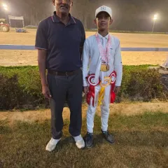 One of our champion riders with his coach, proudly wearing his medals after a successful competition.