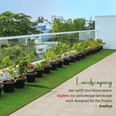For the Aradhya project, we designed a clean and modern terrace garden. This look was achieved by lining the glass railing with potted flowering plants set on a strip of high-quality artificial turf, creating a low-maintenance yet picturesque landscape.