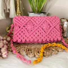 This bright pink macrame bag is all about the details. It showcases an intricate floral-inspired knot pattern and comes with a delicate chain strap, making it perfect for a dressy event.