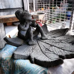 A whimsical sculpture of a creature resting on a leaf, waiting for the Raku firing. Hand-building allows for this kind of storytelling and detailed character work.