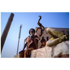 The color version of the sadhu with the snake staff. The blue sky and the earthy tones of his robes and the surroundings bring the scene to life.