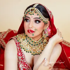 A close-up on the intricate details of this bridal makeup. Notice the perfectly blended eyeshadow and the sharp definition that makes the eyes pop, paired with a classic red lip for that ultimate bridal feel.