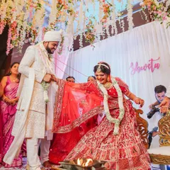 The seven sacred steps of the Pheras, a promise of a lifetime together. This candid shot captures the joy on the bride's face as she and the groom circle the holy fire, marking the beginning of their new journey.