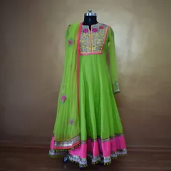 For a vibrant and festive look, I created this neon green Anarkali suit. It features detailed floral threadwork and mirror work on the yoke, with a matching pink border and playful tassels, making it perfect for a wedding sangeet or festive celebration.