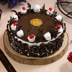 A rich Black Forest cake, styled for a bakery's online menu. We ensure key details like the chocolate shavings, whipped cream, and cherries are perfectly captured.