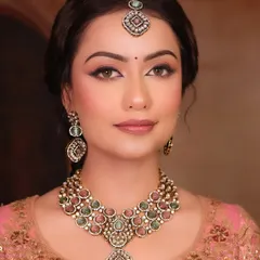 A beautiful portrait showcasing the 'Sundar' look. The focus is on flawless skin and elegant, understated makeup that lets the bride's natural beauty shine through.