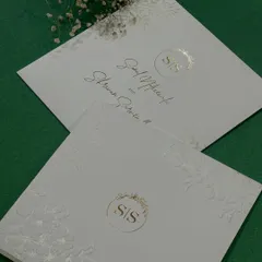 Another view of our classy and minimal design, showcasing the beautiful texture of the paper and the delicate gold foil monogram.
