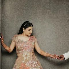 A tender moment of connection. The groom gently holds his bride's hand, a simple, intimate gesture that speaks volumes about their bond.