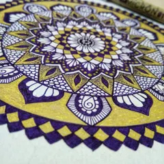 A detailed close-up of the violet and gold mandala as it's being created. I used a Micron pen for the violet details and a Uniball pen for the metallic gold, showing how different tools can be combined.