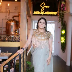 An outfit photoshoot with a model in a gorgeous fringed blouse and saree. The makeup is designed to complement the high-fashion look.