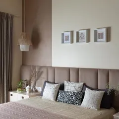 A beautifully textured bedroom from the Lakshya project. The soft, upholstered headboard, layered bedding, and a mix of neutral tones with a hint of mauve create a space that is effortlessly elegant and comfortably livable.