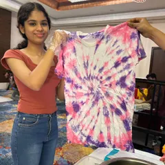 A stunning spiral pattern created with purple and pink dyes. Our tie-dye workshops are a lesson in color theory and chemical reactions.