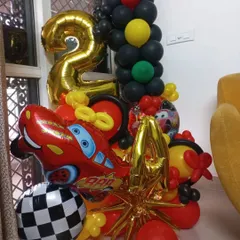 Here is a balloon bouquet for a 2nd birthday based on the Disney movie 'Cars'. It features a large Lightning McQueen foil balloon, a number '2' foil, and a checkered racing flag balloon.