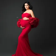 Capturing the perfect profile in our client-favorite red Rosa gown. The form-fitting design beautifully highlights the baby bump, making it a perfect choice for a glam maternity shoot.