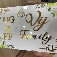 An elegant acrylic nameplate for the 'Vij Family.' This design combines golden letters with a beautiful floral print border.