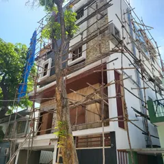 A building in Bangalore during the exterior finishing stage. The scaffolding is up as our team applies the stone cladding and other facade elements from our 3D design.