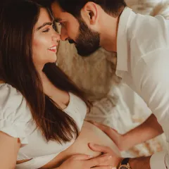 This close-up shot captures the tender connection between the expecting parents. Lifestyle maternity sessions are all about these quiet, unposed moments of love.