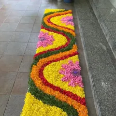 A long and colorful floral runner for a walkway. I used petals of different flowers to create a vibrant, flowing pattern on the floor.