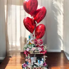 Celebrate your love story with a grand gesture. This anniversary hamper combines romantic elements like heart-shaped balloons, fine wine, personalized photo frames, and fresh flowers to create a breathtaking moment.