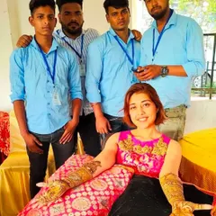 My team and I with a happy client after completing her intricate bridal mehandi. We work together to ensure even the most detailed designs are completed comfortably.