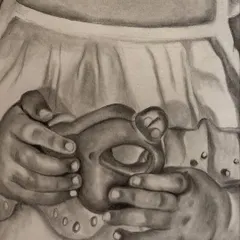A close-up of a baby sketch, focusing on the tiny hands holding a toy. For me, these small details are what bring a portrait to life and tell a bigger story.